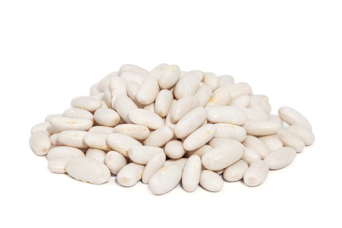 Pile of uncooked Great Northern Beans isolated on white background. 