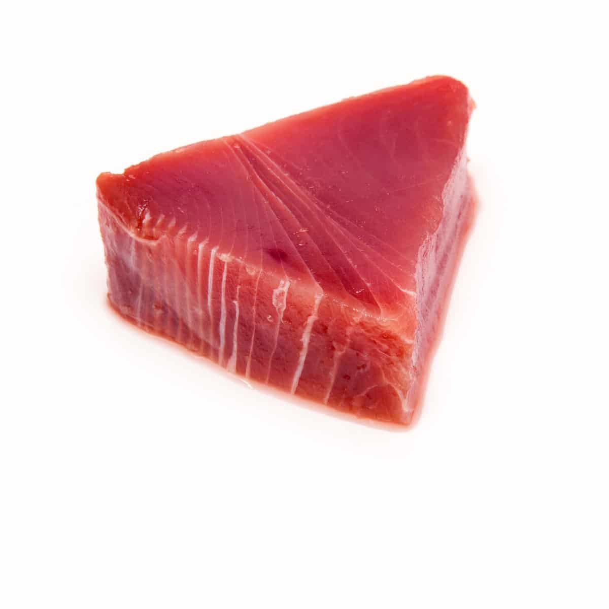 Raw yellowfin tuna steak on white background