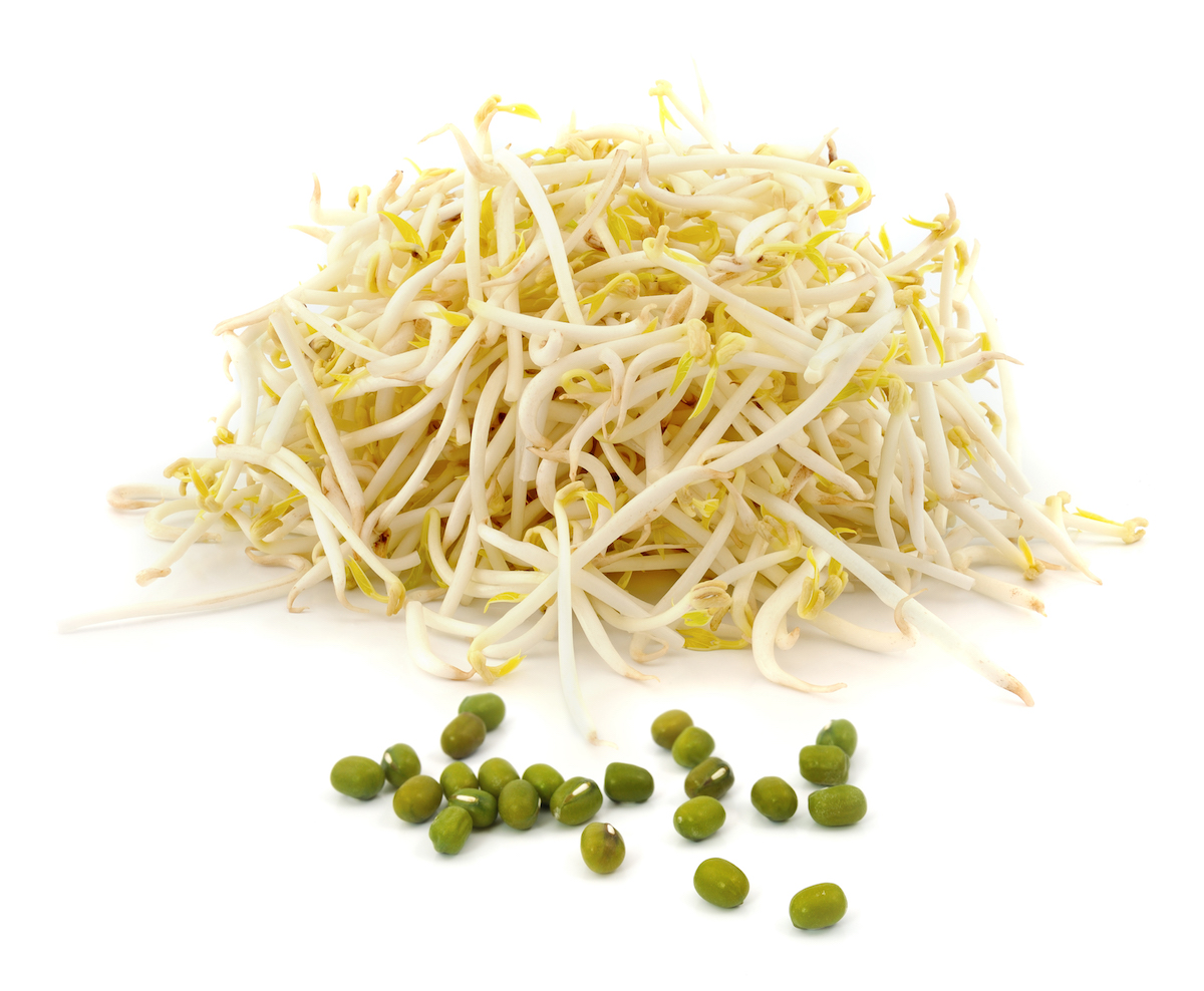 Mung bean sprouts and raw mung beans on white background