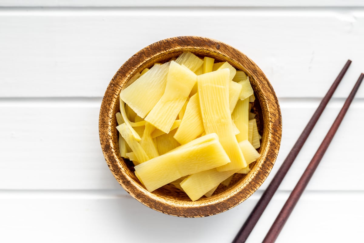 Sliced canned bamboo shoots in a wooden bowl.