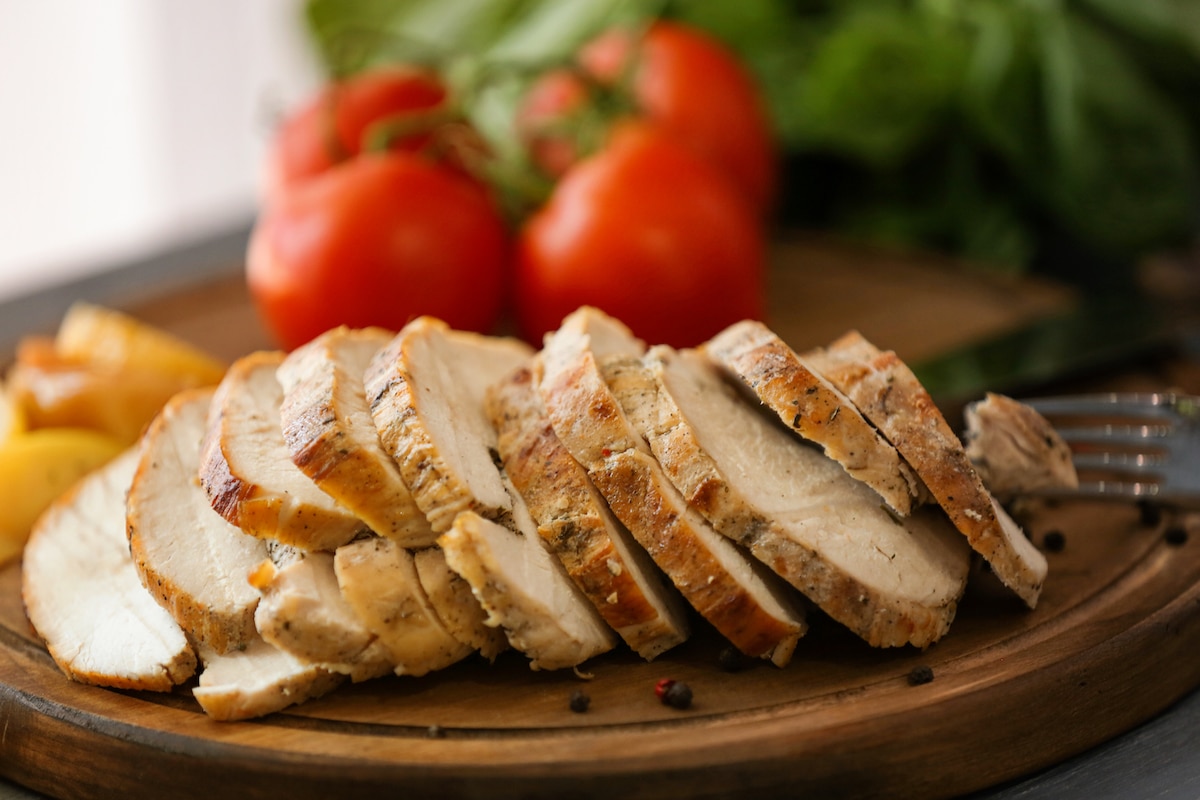 sliced turkey breast on a wooden platter