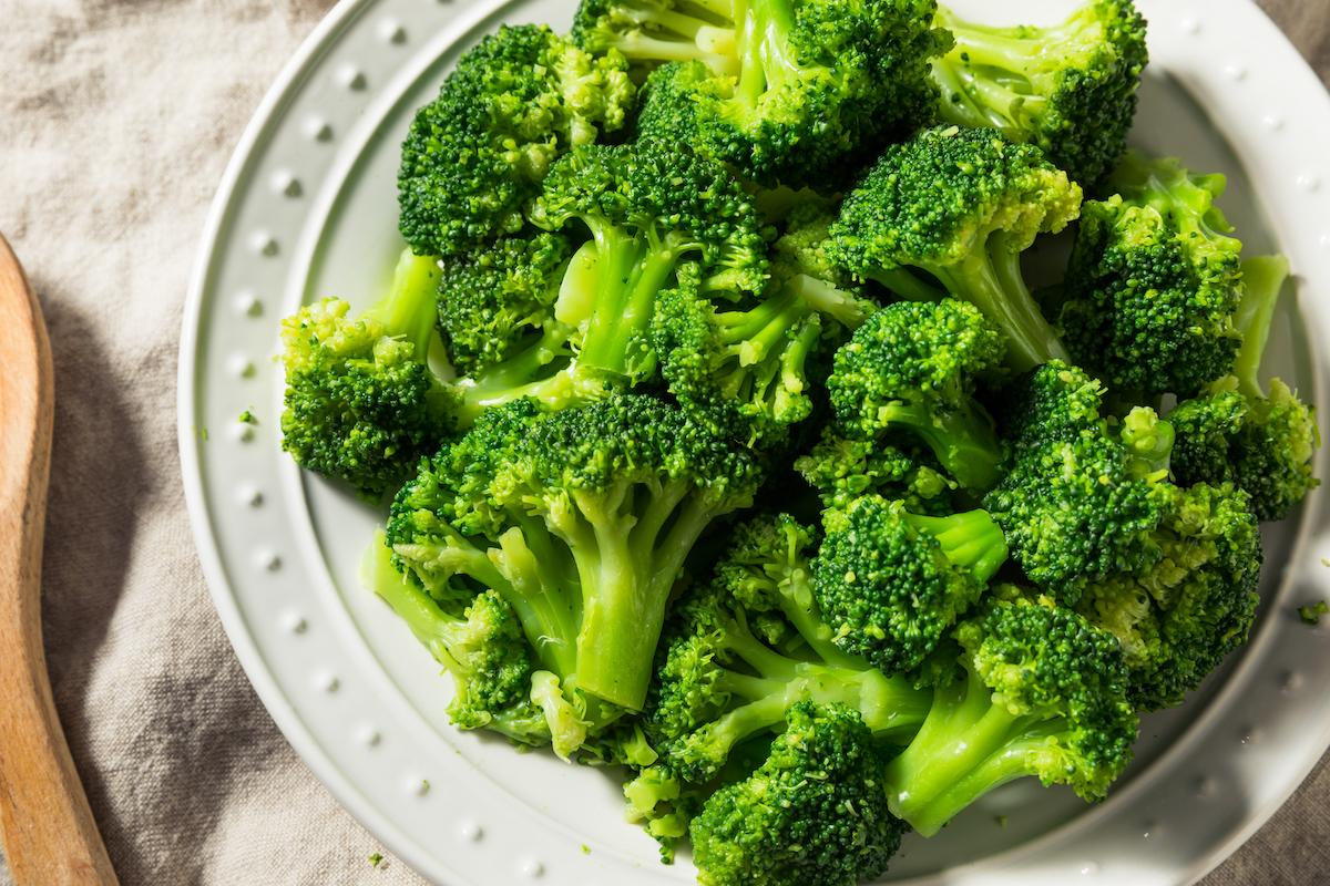 steamed broccoli on a round white plate