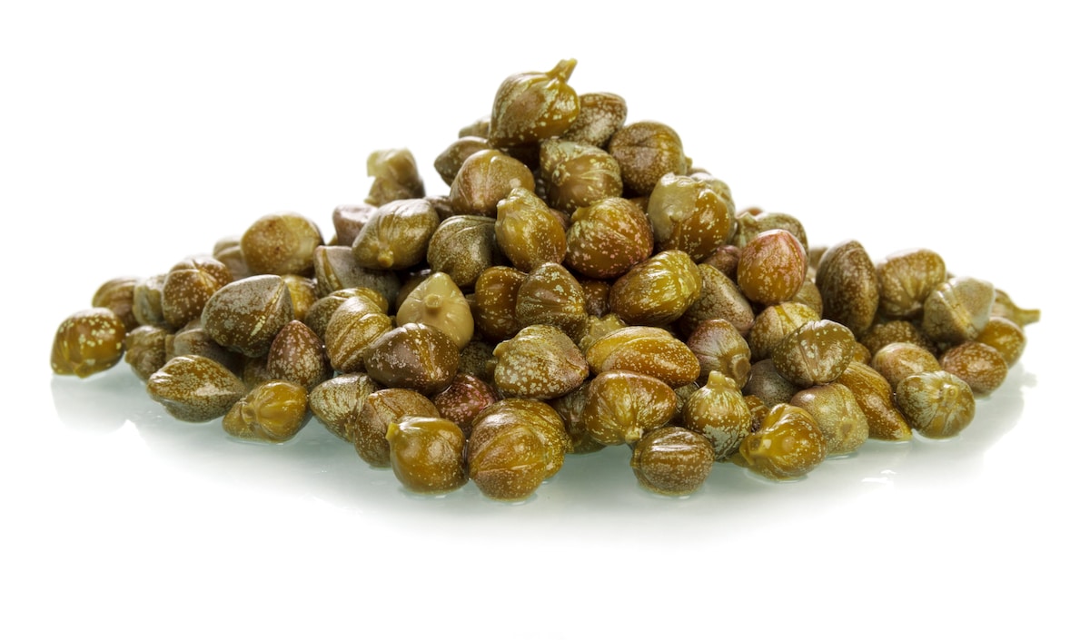 Brined capers on a white background.